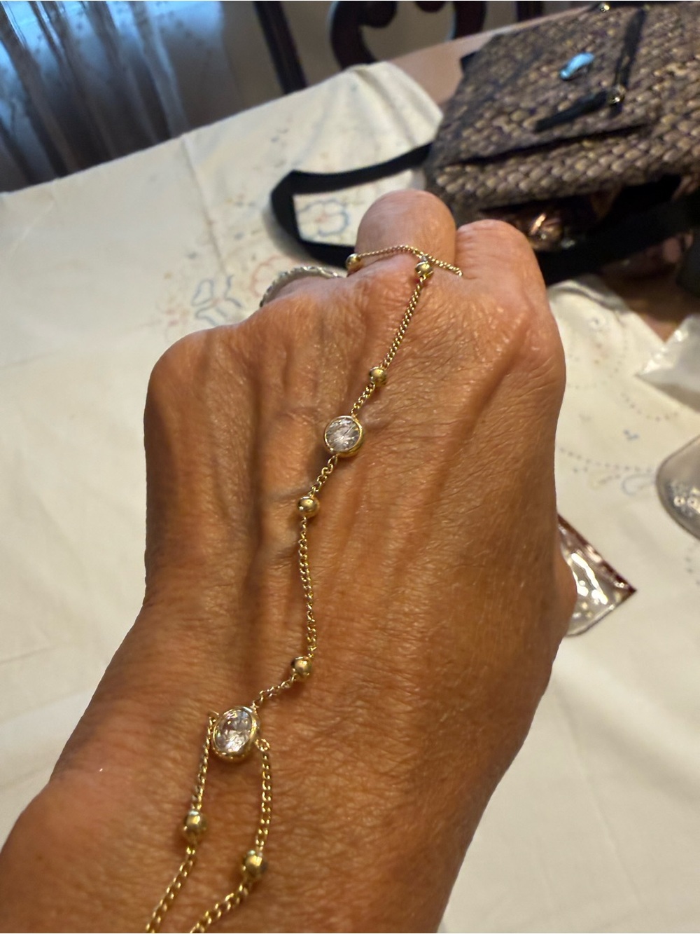 Gold Tone Hand Chain Bracelet with Clear Stones